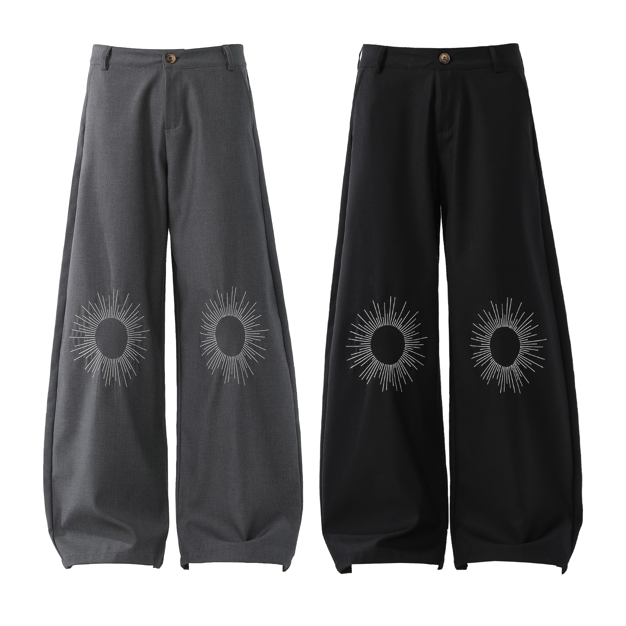 Omirad wide-leg pants in grey and black with white sunburst graphic embroidery at the lower leg, flat lay product shot