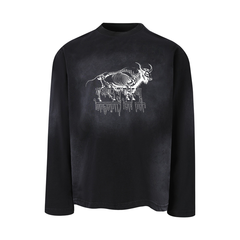 Black long-sleeve tee with white skeleton bull graphic and dripping text on the chest