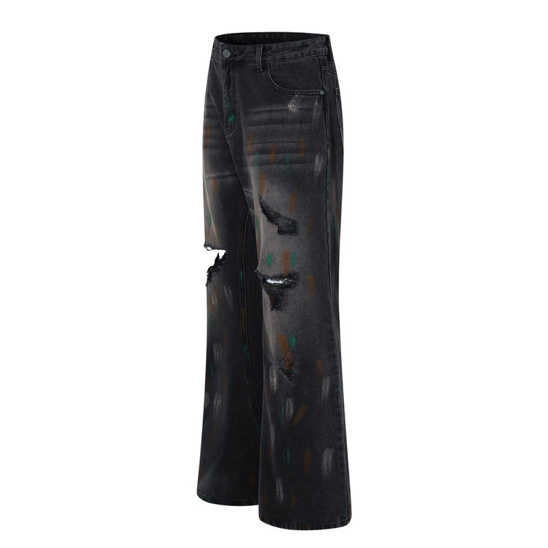 Angled front view of washed black wide-leg jeans with ripped knees and painted distressing