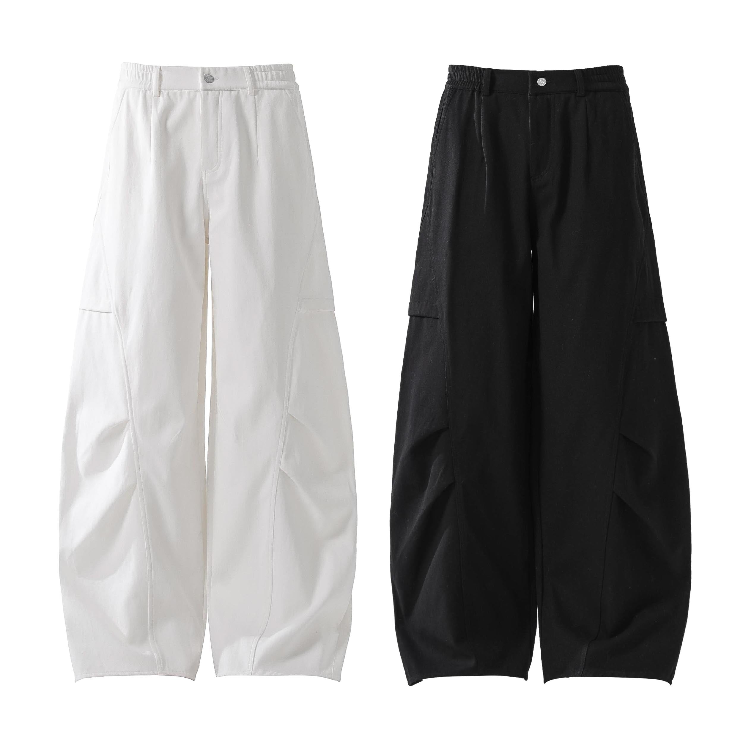 White and black minimal panel wide-leg cotton pants with elastic waistband and side pockets, flat lay product shot
