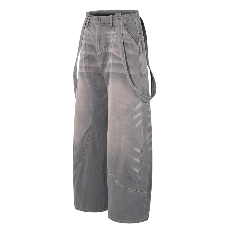 Three-quarter view of gray washed cargo jeans showing side strap detail and wide legs