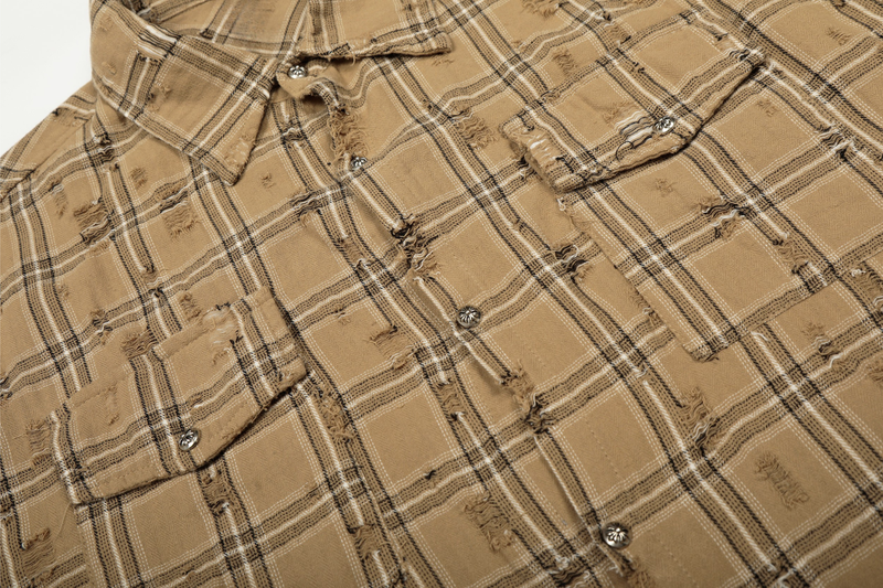 Close-up of tan plaid overshirt chest with flap pockets and button closure