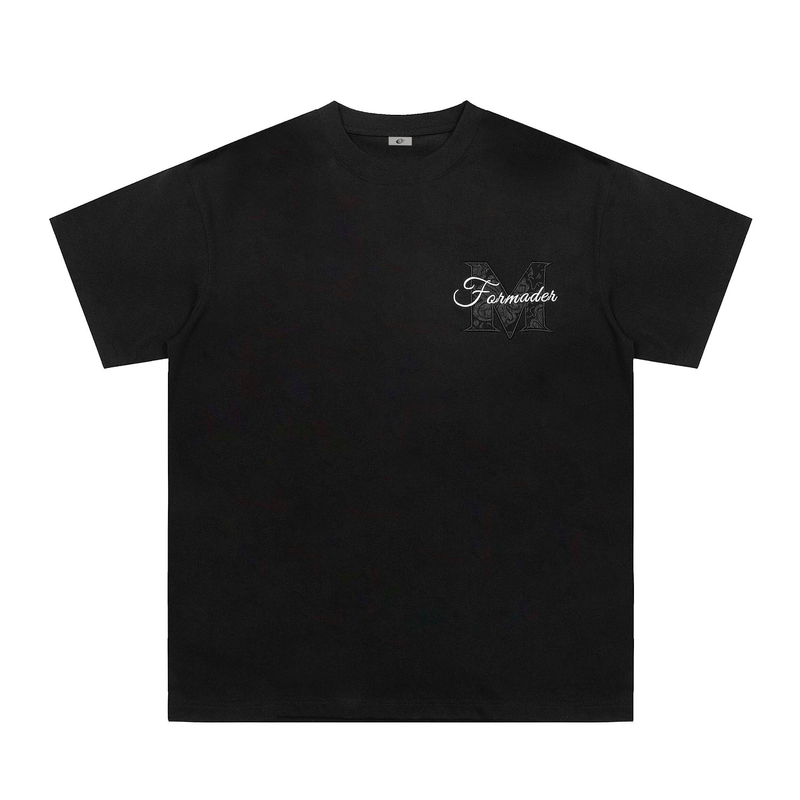 Black streetwear graphic tee with a subtle floral panel logo on the chest and oversized relaxed fit