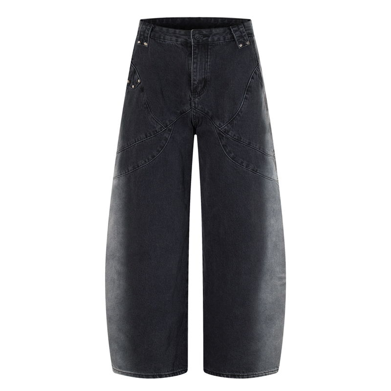 Front view of washed black wide-leg jeans with curved seam detailing and rivet accents
