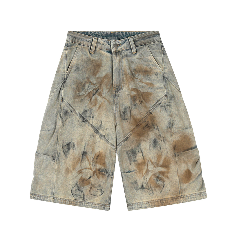 Front view of wide-leg denim shorts with vintage spray-dye wash and angled front pockets