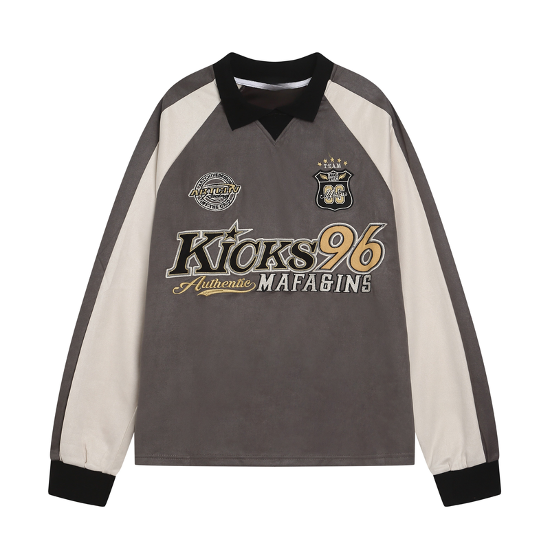 Front view of a gray varsity rugby top with cream sleeves, black collar, and embroidered chest patches