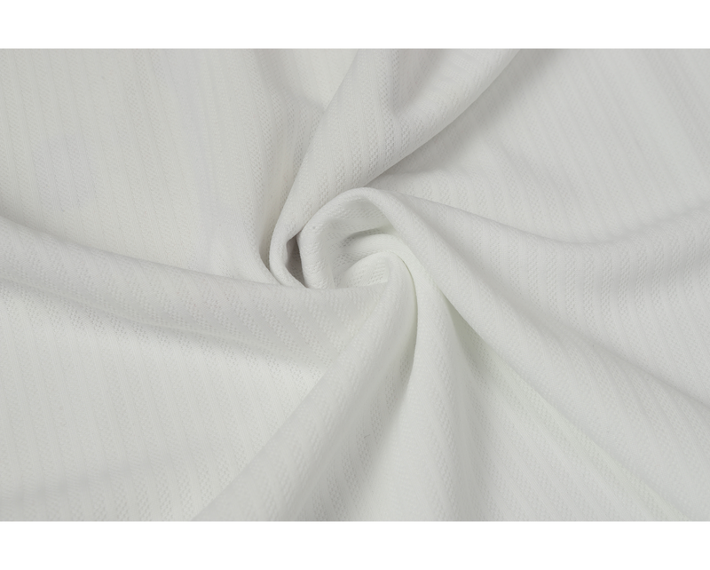 Close-up of smooth white mesh jersey fabric folded in a swirl