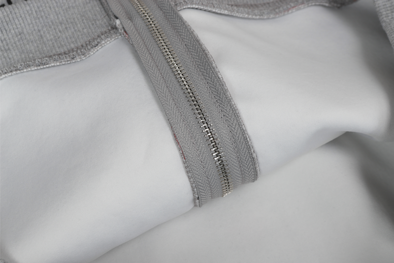 Close-up of gray hoodie zipper track and inner lining