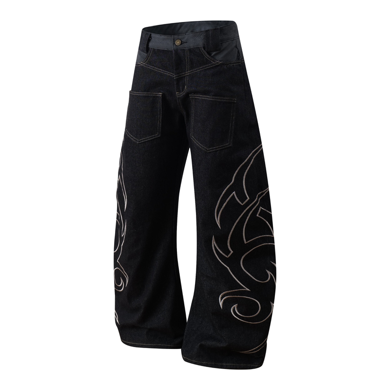 Angled front view of dark denim balloon jeans with tribal embroidery and wide legs