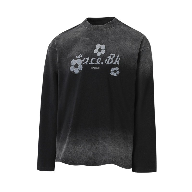 Black long-sleeve tee front view with centered soccer ball graphics and faded lettering