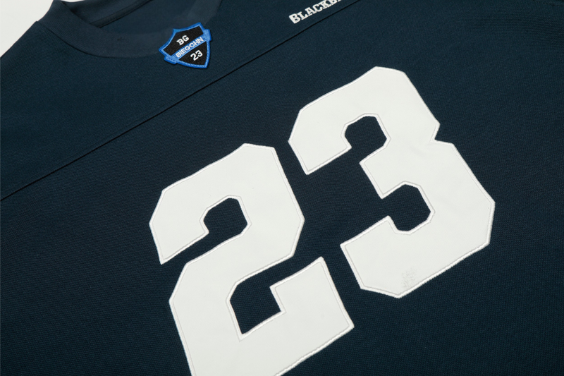 Close-up of navy tee front with large white 23 number graphic and chest patch