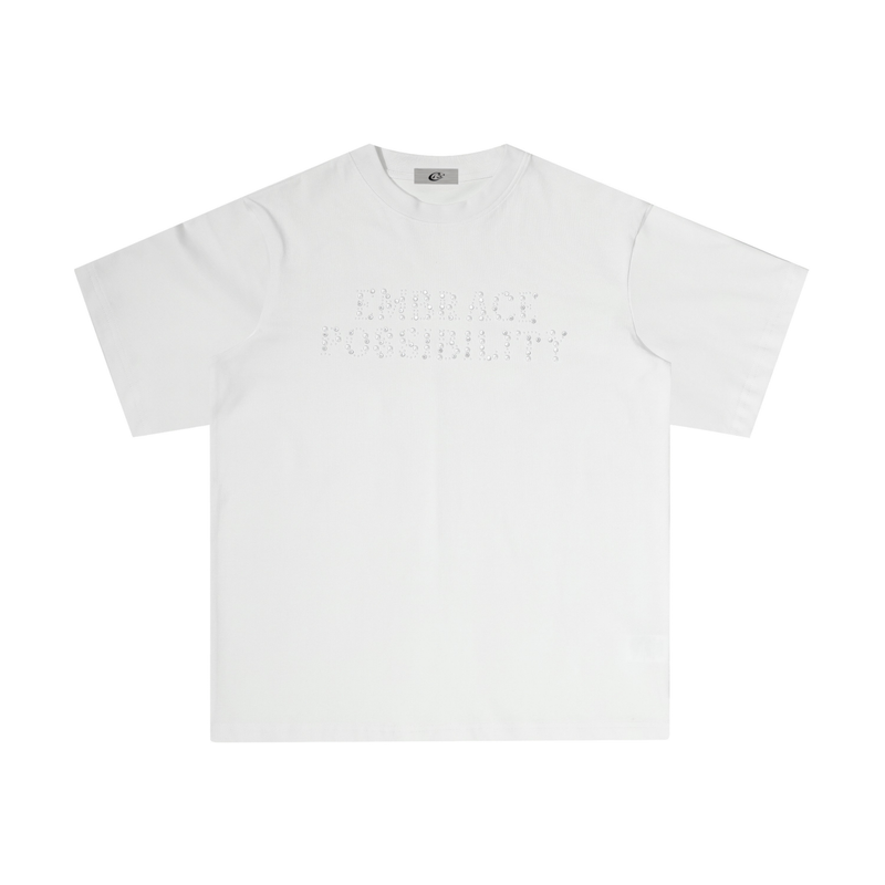 White oversized T-shirt with rhinestone Embrace Possibility lettering on the chest