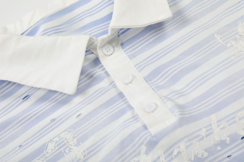 Close-up of white button placket and collar on light blue striped polo shirt