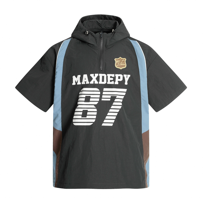 Black hooded half-zip jersey with MAXDEPY 87 graphic, blue side panels, and varsity streetwear styling