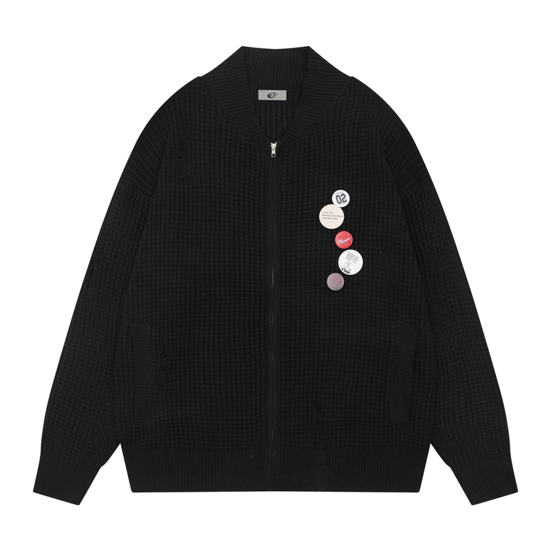 Black waffle knit zip cardigan with badge pins and distressed details, front view