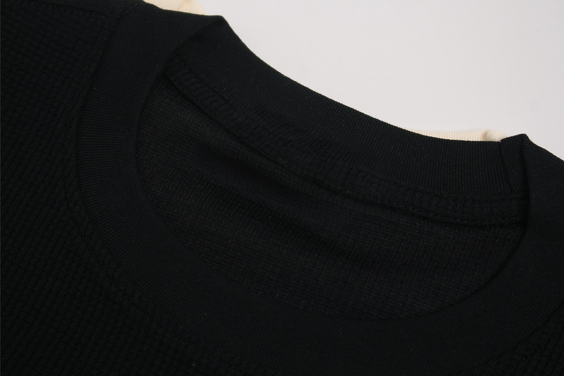 Black waffle knit tee with a ribbed crew neckline and textured vintage streetwear fabric detail