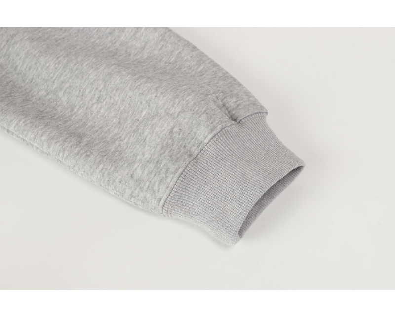 Close-up of light gray ribbed sleeve cuff on hoodie