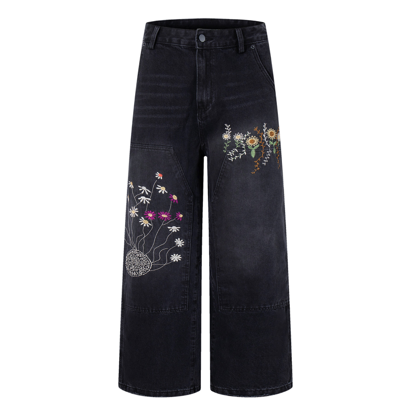 Front view of washed black wide-leg carpenter jeans with floral embroidery on both legs