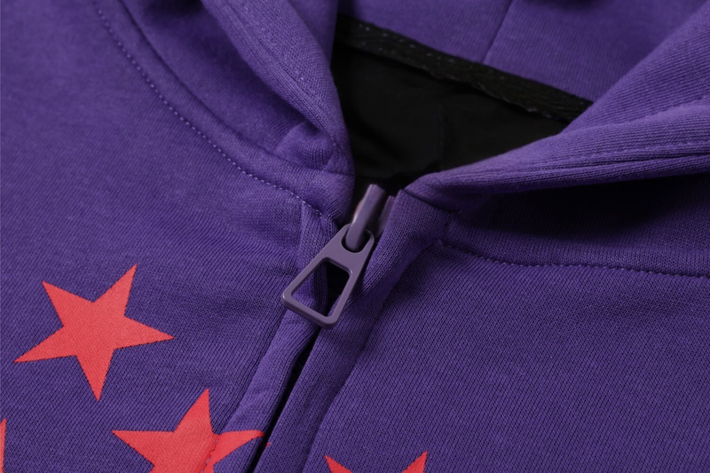 Close-up of purple hoodie zipper and red star graphic detail