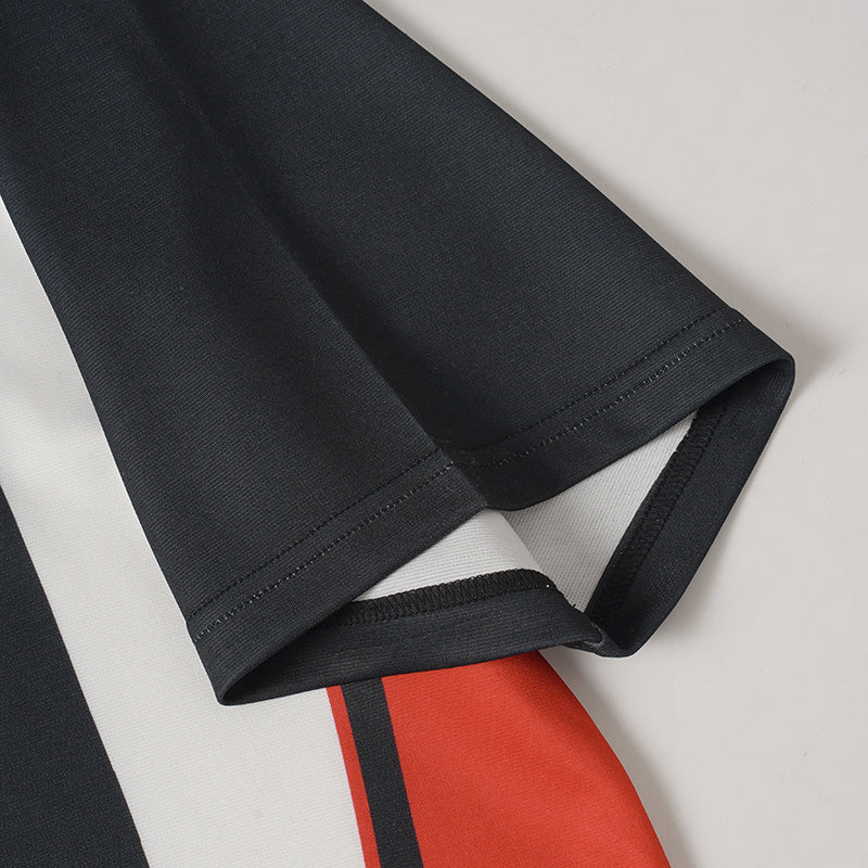Black performance jersey sleeve with white and red vertical stripe accents and stitched hem detail