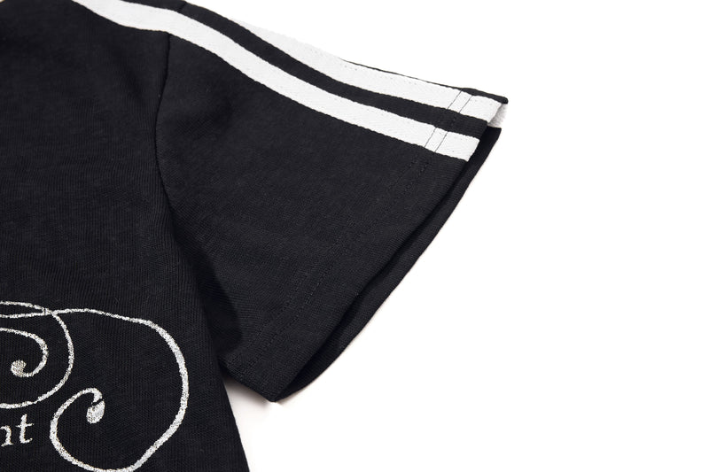 Black graphic polo shirt sleeve with white contrast stripes and script print on the chest, vintage streetwear style