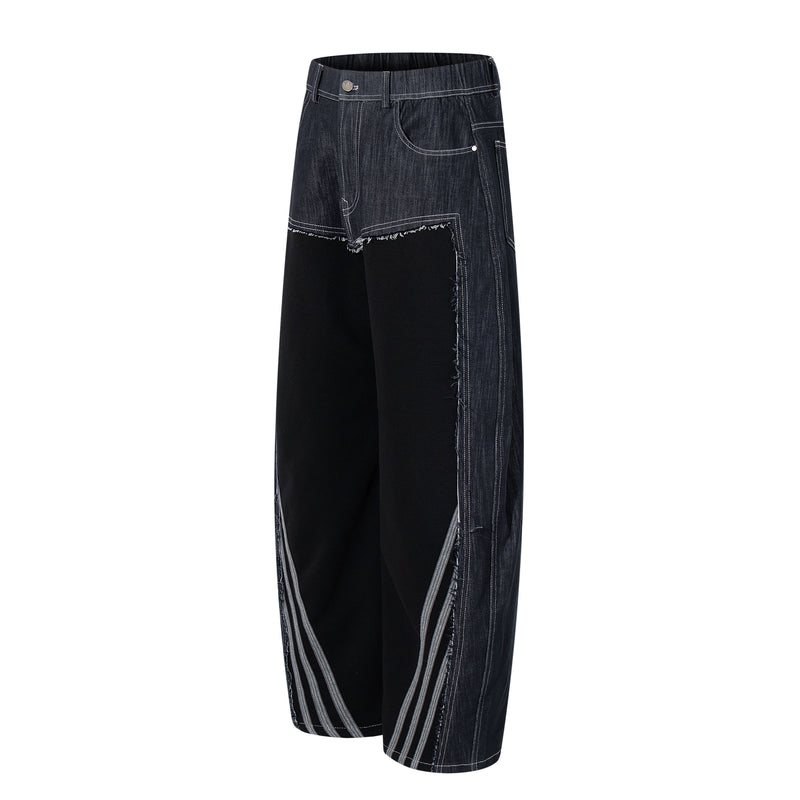 Front angled view of dark denim wide-leg jeans with black jersey panels and side seam details