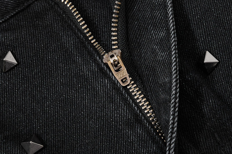 Close-up of the front zipper on black denim jeans