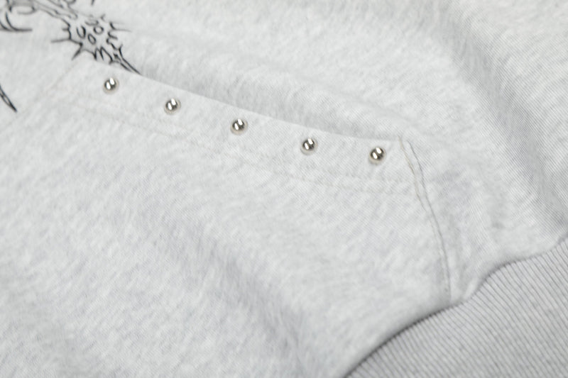 Close-up of light gray hoodie kangaroo pocket with metal rivets