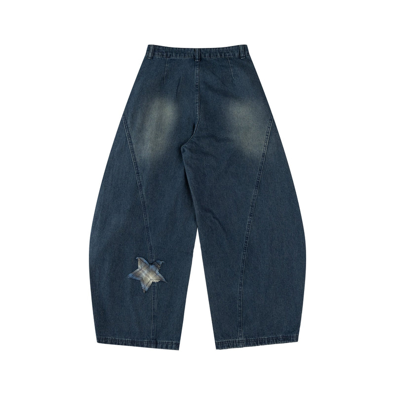 Back view of dark blue wide-leg jeans with a single star patch on the lower leg