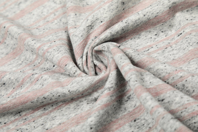 Close-up of gathered gray striped fabric with pink and black flecks