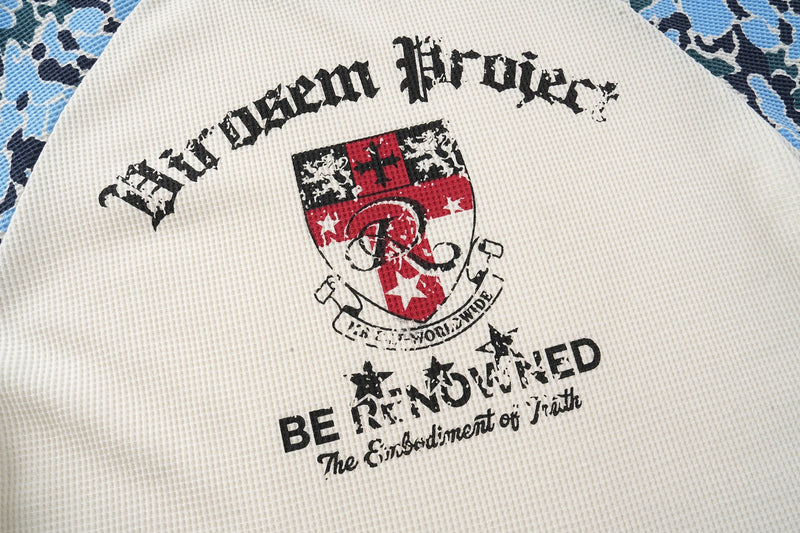 Front graphic view of cream waffle-knit tee with distressed crest print and red shield logo