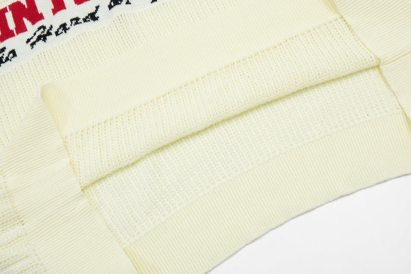 Cream knit varsity polo shirt with ribbed cuffs and collegiate lettering detail on the chest
