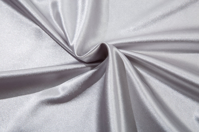 Close-up of white jersey tee fabric with gathered texture and sheen
