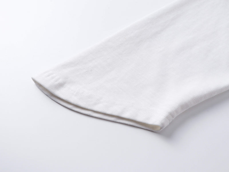 Close-up of folded white sleeve hem on vintage washed cotton tee