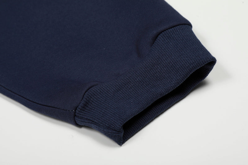 Close-up of navy ribbed cuff and sleeve hem on the hoodie