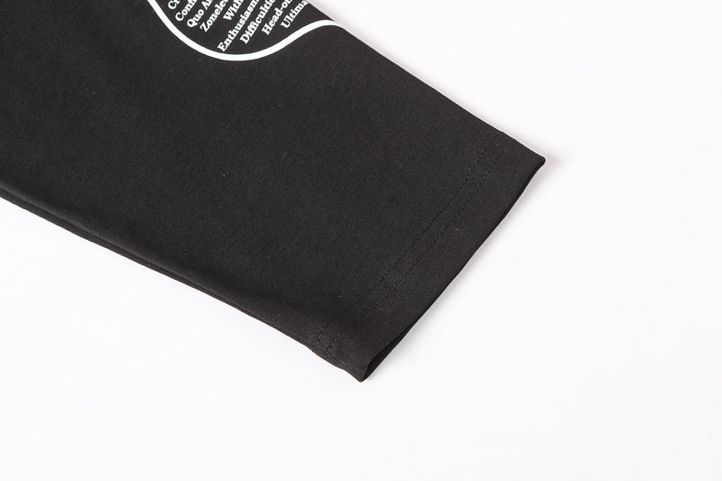 Close-up of black sleeve cuff with stitched hem and partial sleeve print