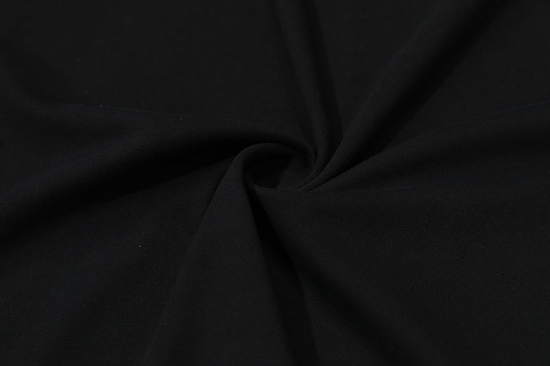 Black oversized T-shirt fabric with a smooth draped texture and subtle folds for a minimalist fashion look