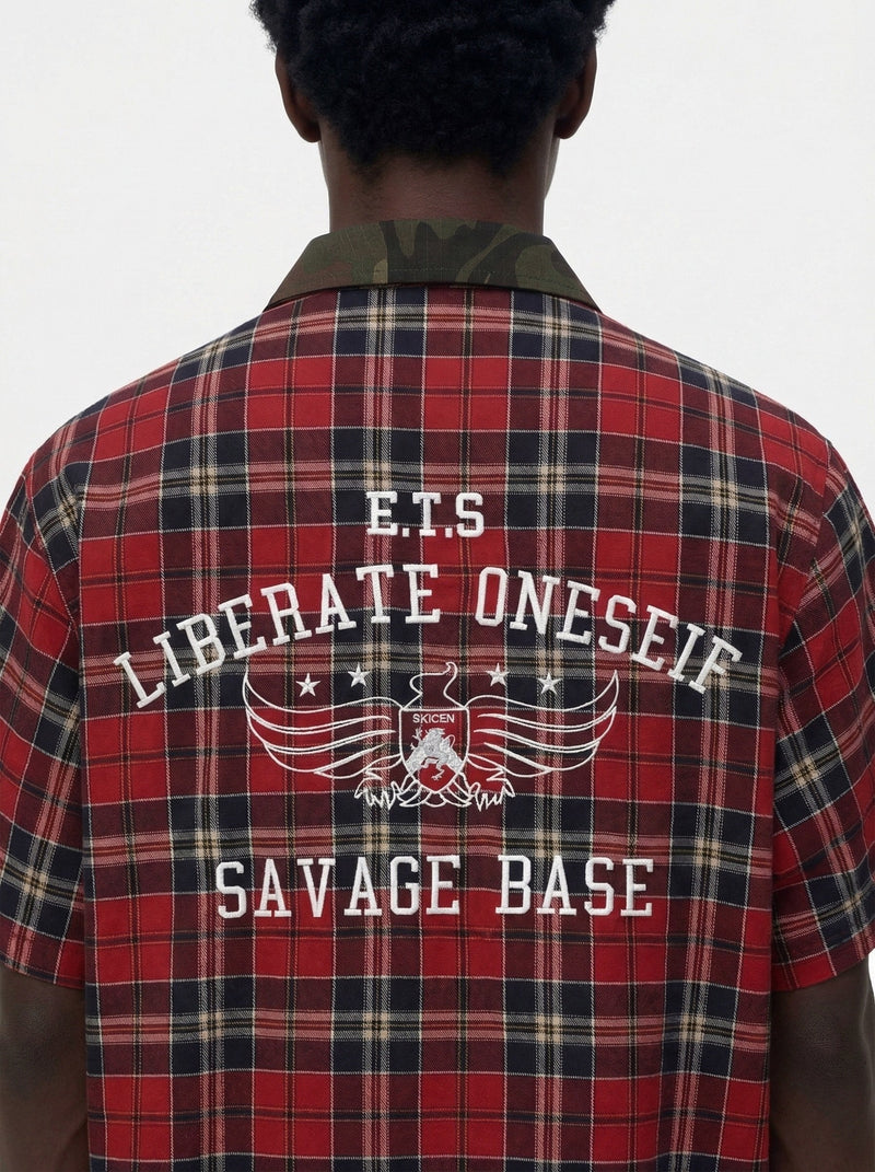 Back view of a red plaid shirt with camo collar and bold graphic text reading Liberate Oneself Savage Base