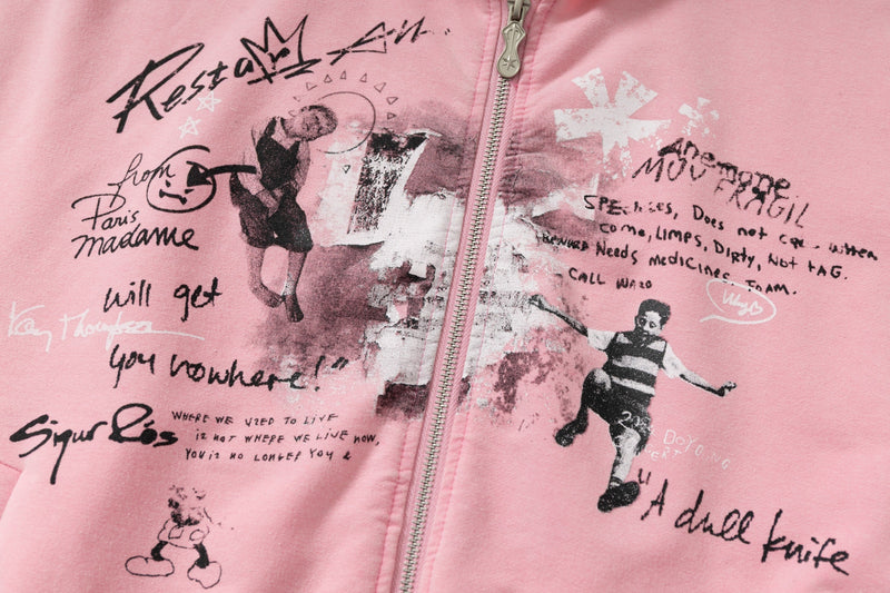 Close-up of pink hoodie front graphic print and zipper