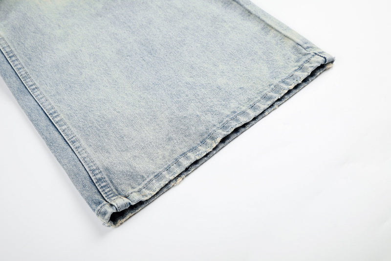 Cuffed hem detail on light wash wide-leg denim jeans