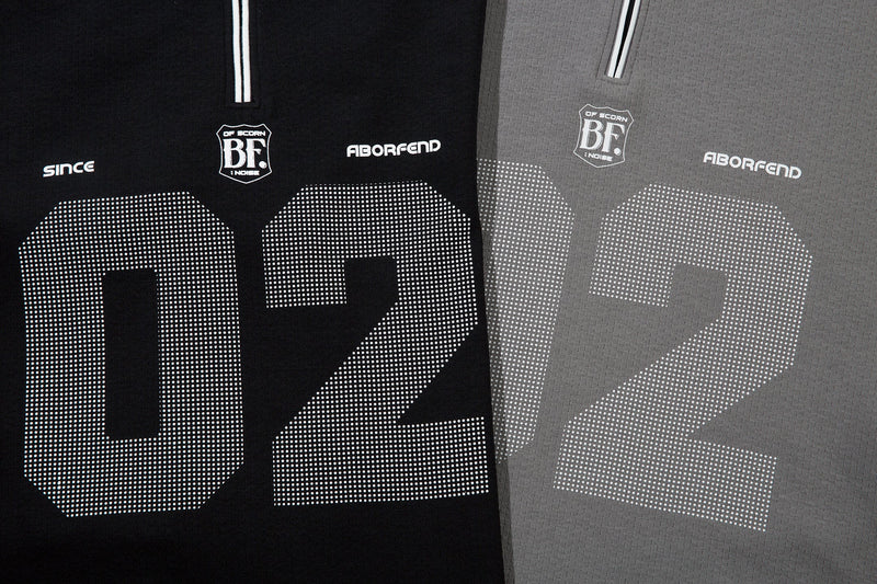 Close-up of black and gray 02 graphic print on the long sleeve polo shirt