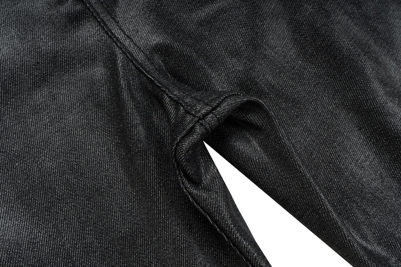Close-up of black coated denim inseam and inner leg seam