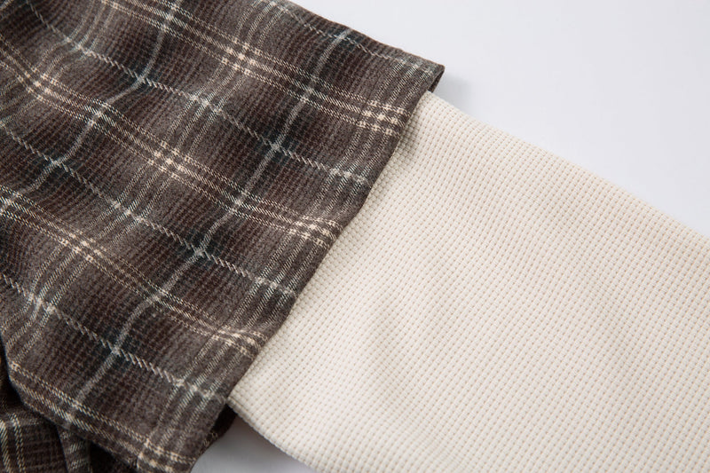 Side sleeve detail showing brown plaid short sleeve over cream long sleeve