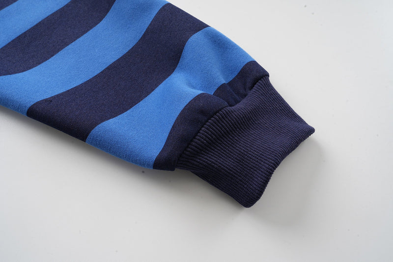 Close-up of ribbed navy cuff on striped hoodie sleeve