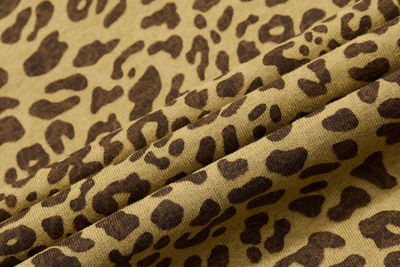 Close-up of vintage leopard print knit fabric in tan and brown, showing the textured pattern of a Y2K streetwear polo tee