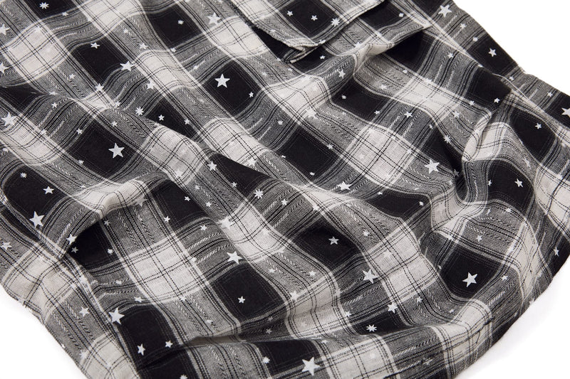 Wrinkled plaid fabric close-up on black and white star print cargo shorts
