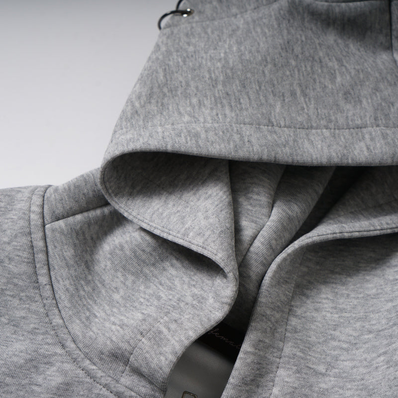 Close-up of gray hood fabric and cat ear detail with black metal eyelets