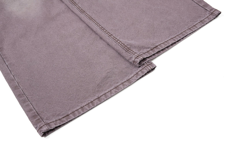 Close-up of folded brown denim leg hem