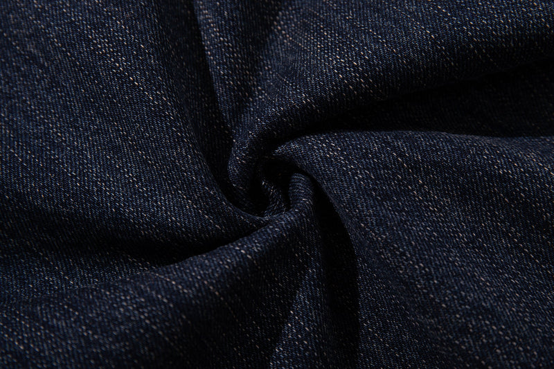Close-up of dark wash denim fabric with a soft folded texture