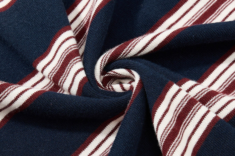 Close-up of navy knit fabric with burgundy and white vintage rugby stripes on a retro polo shirt